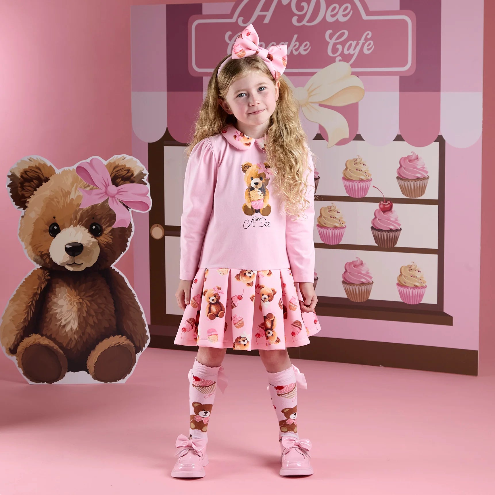 A Dee Meadow girls dress with Peter Pan collar and teddy bear bakery print – front