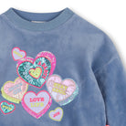 Close-up of Billieblush blue sweatshirt with multicoloured hearts