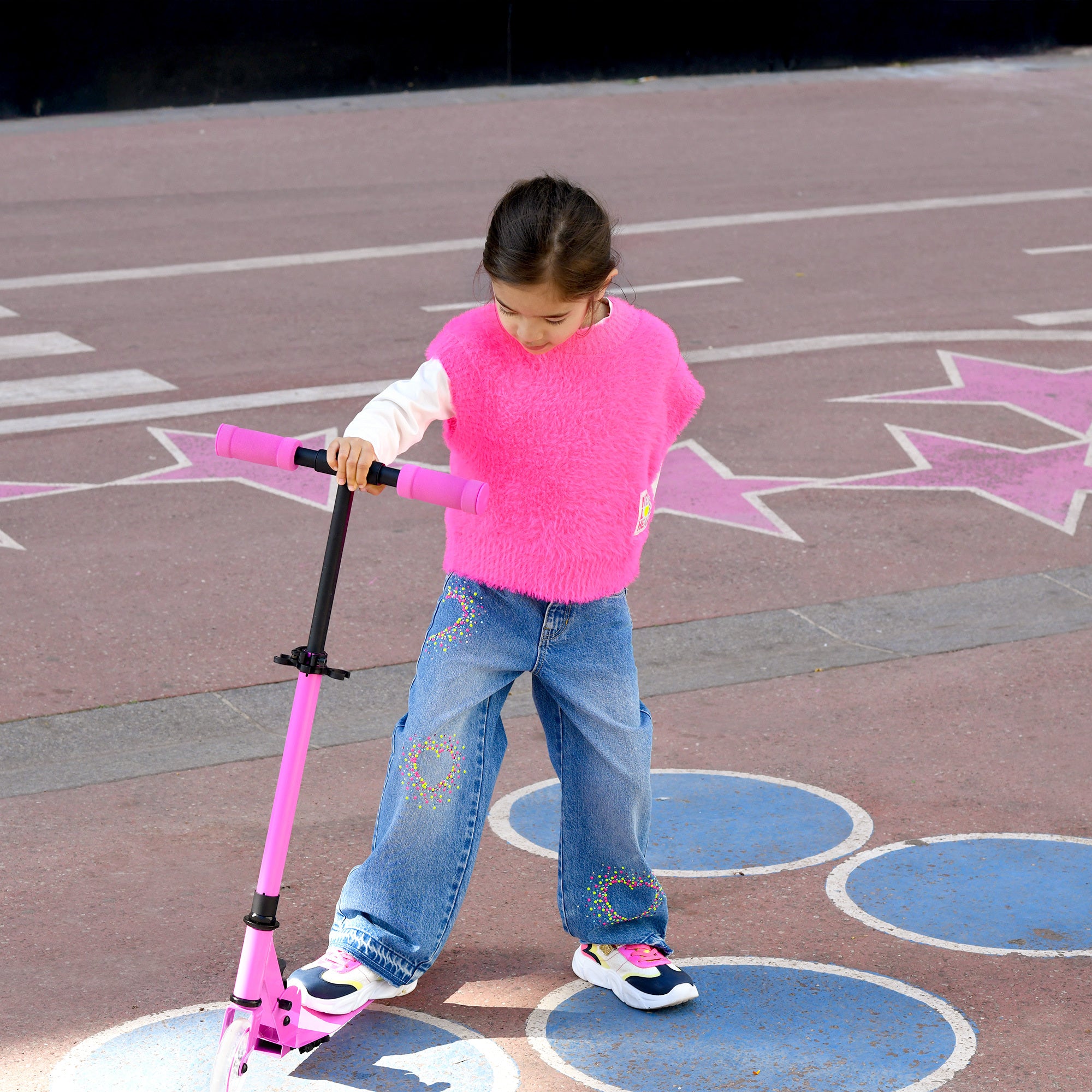 Girl wearing Billieblush blue wide leg jeans with pink top and trainers