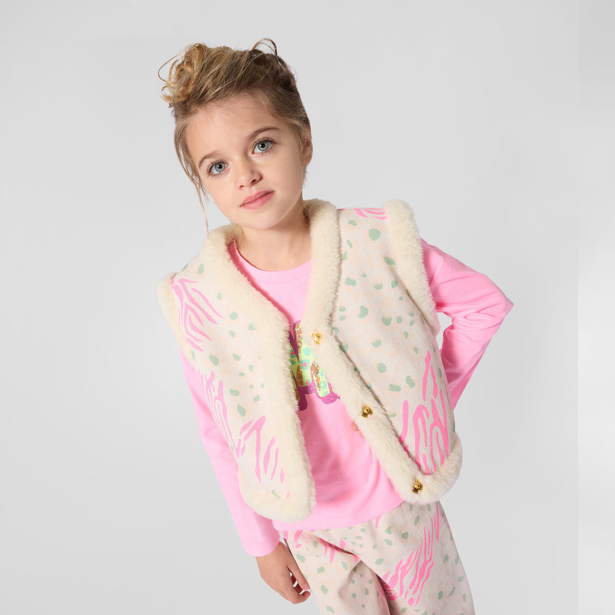 Billieblush girls cream printed gilet with pink detailing worn over a pink top