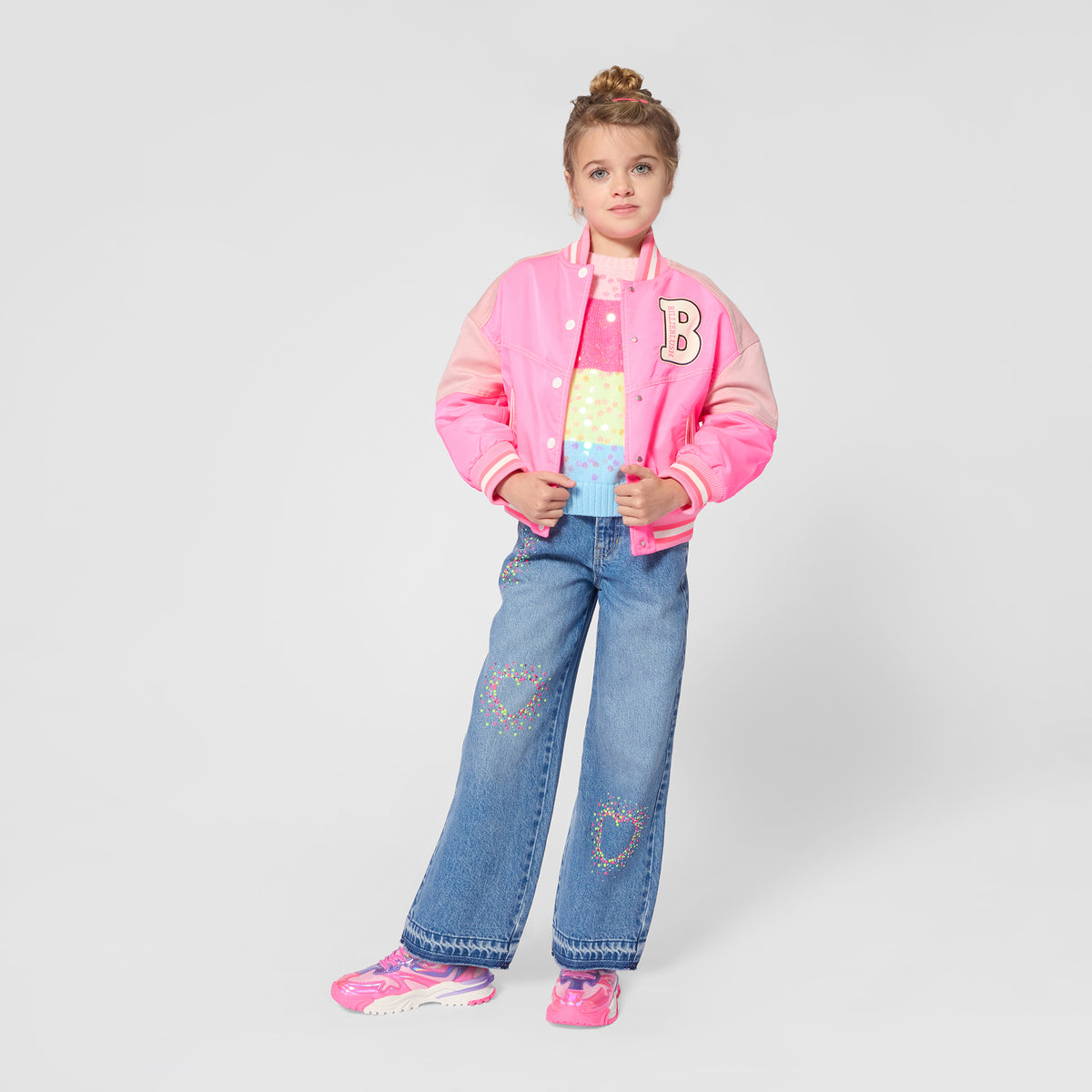 Billieblush girls colourful striped knit jumper styled with jeans and a pink varsity jacket