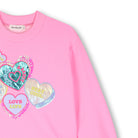 Close-up of colourful heart graphics on Billieblush pink sweatshirt dress