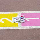 Billieblush girls metallic silver trainers photographed on colourful pavement