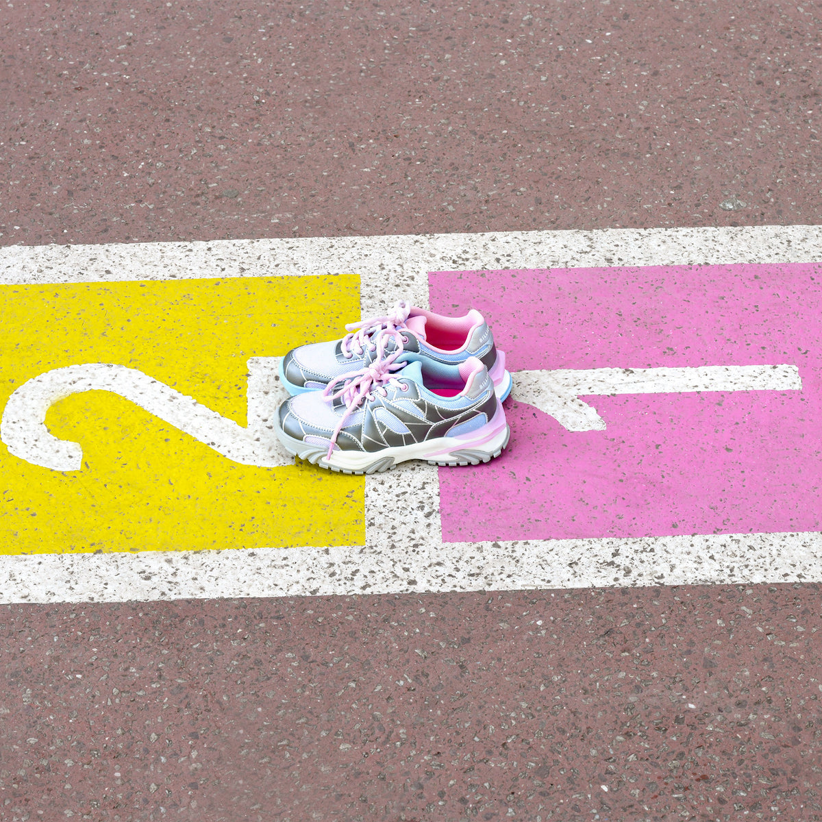 Billieblush girls metallic silver trainers photographed on colourful pavement