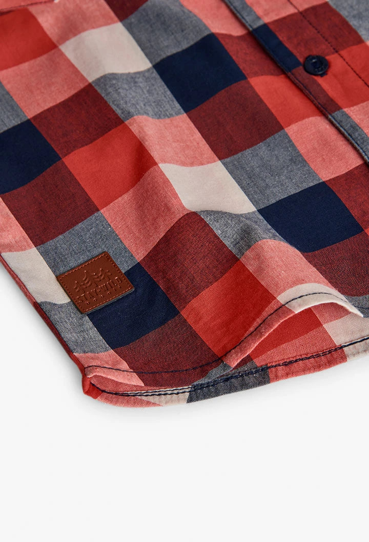 Fabric detail of Boboli boys check shirt showing red, navy and white check pattern