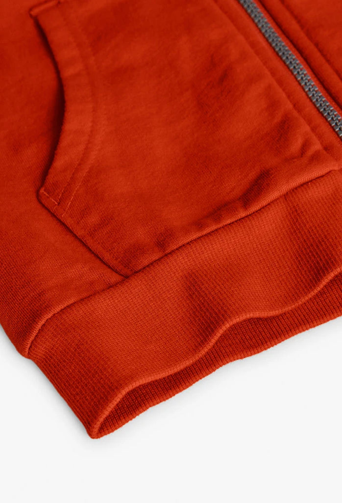 Close-up of pocket and hem on Boboli boys orange cotton hoodie