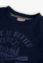 Close-up of slogan and oar motif print on the front of Boboli Boys navy fleece sweatshirt.
