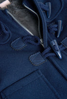 Close-up of toggle fastenings and soft lining on Boboli boys navy duffle coat
