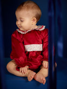 Baby girl wearing Deolinda Frosty red Christmas romper with floral collar