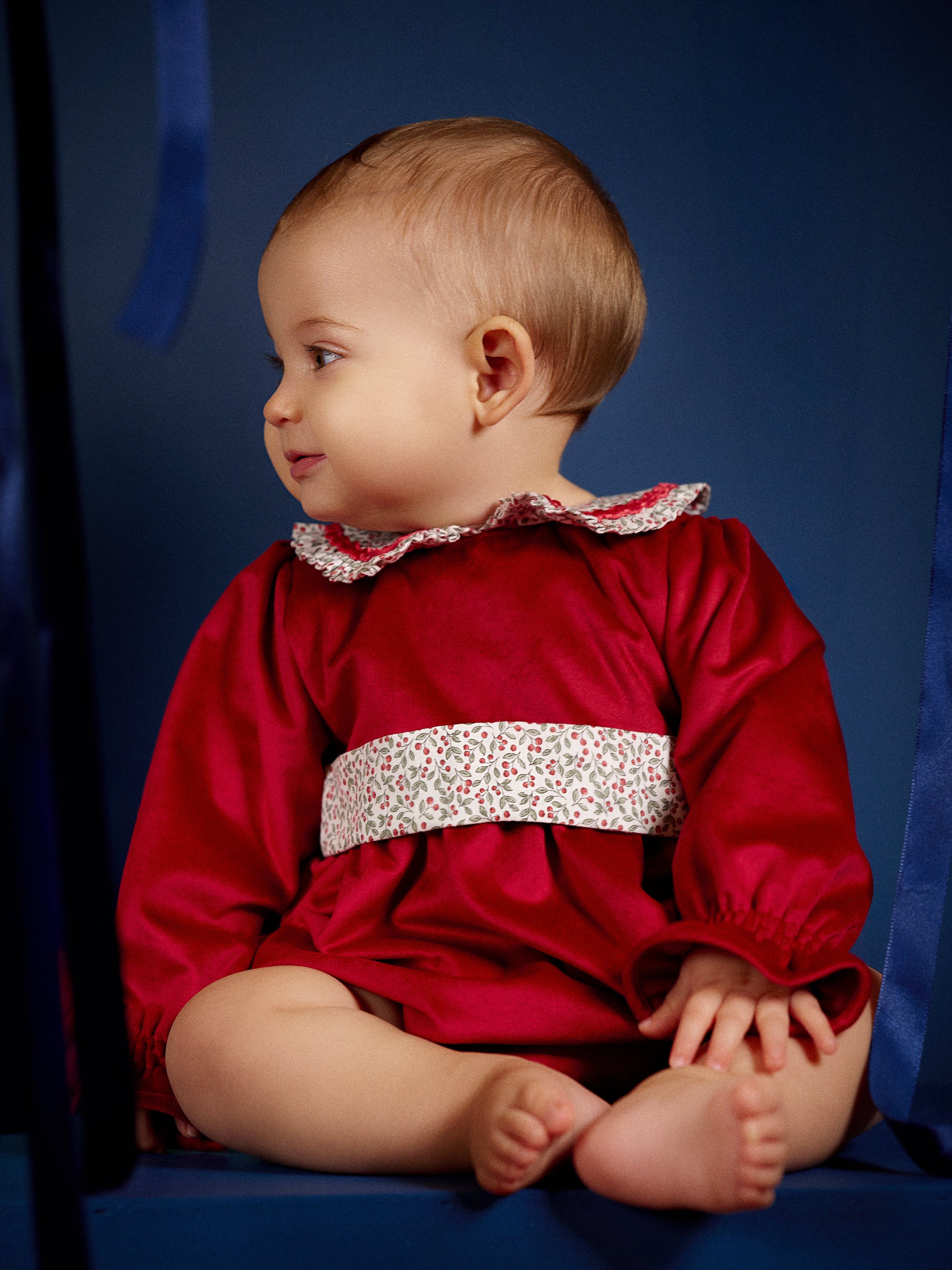 Baby girl wearing Deolinda Frosty festive red romper side view