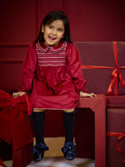 Girl wearing Deolinda Jolly red smocked Christmas party dress