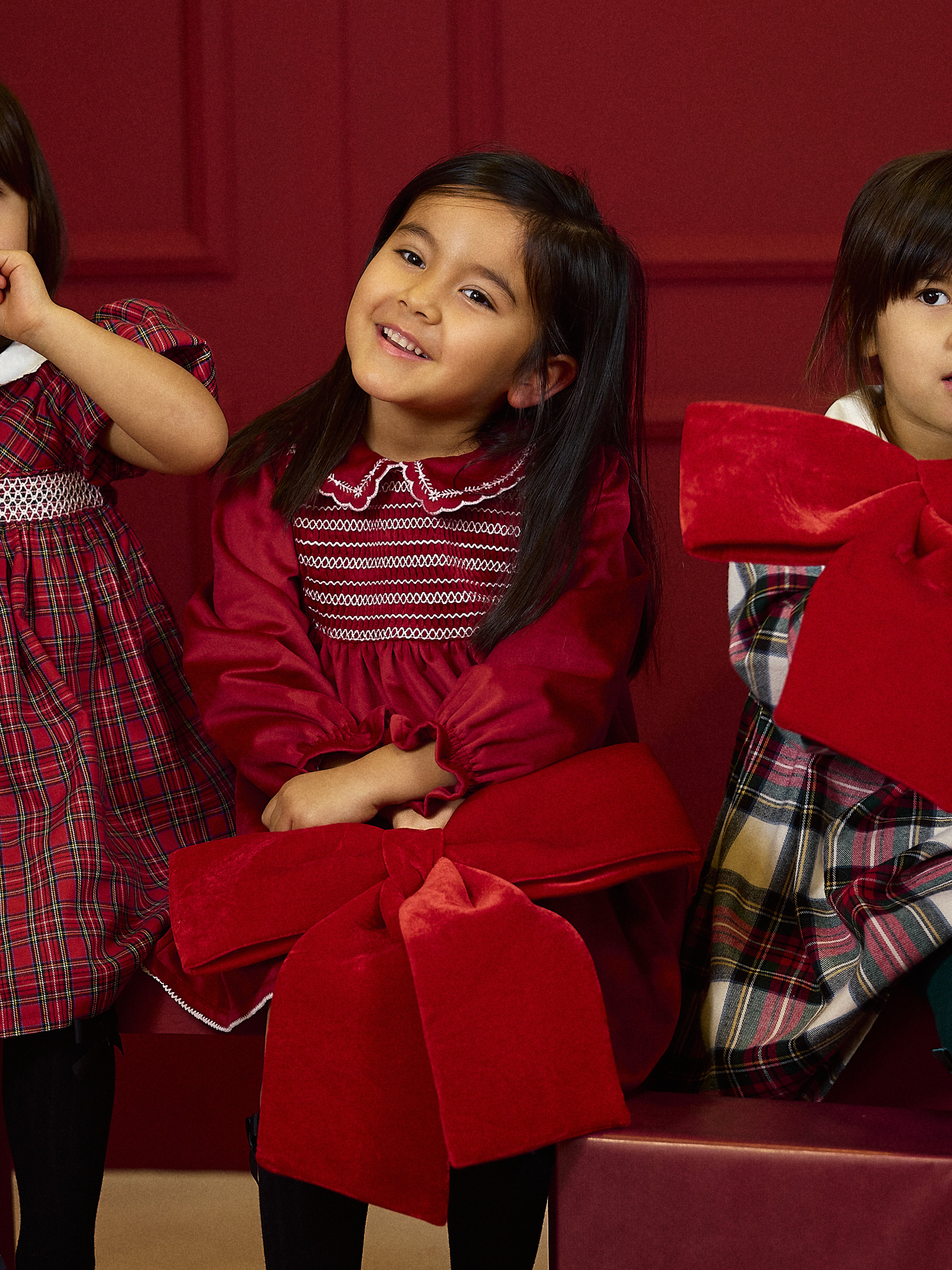 Deolinda Jolly girls red Christmas day dress in festive campaign setting