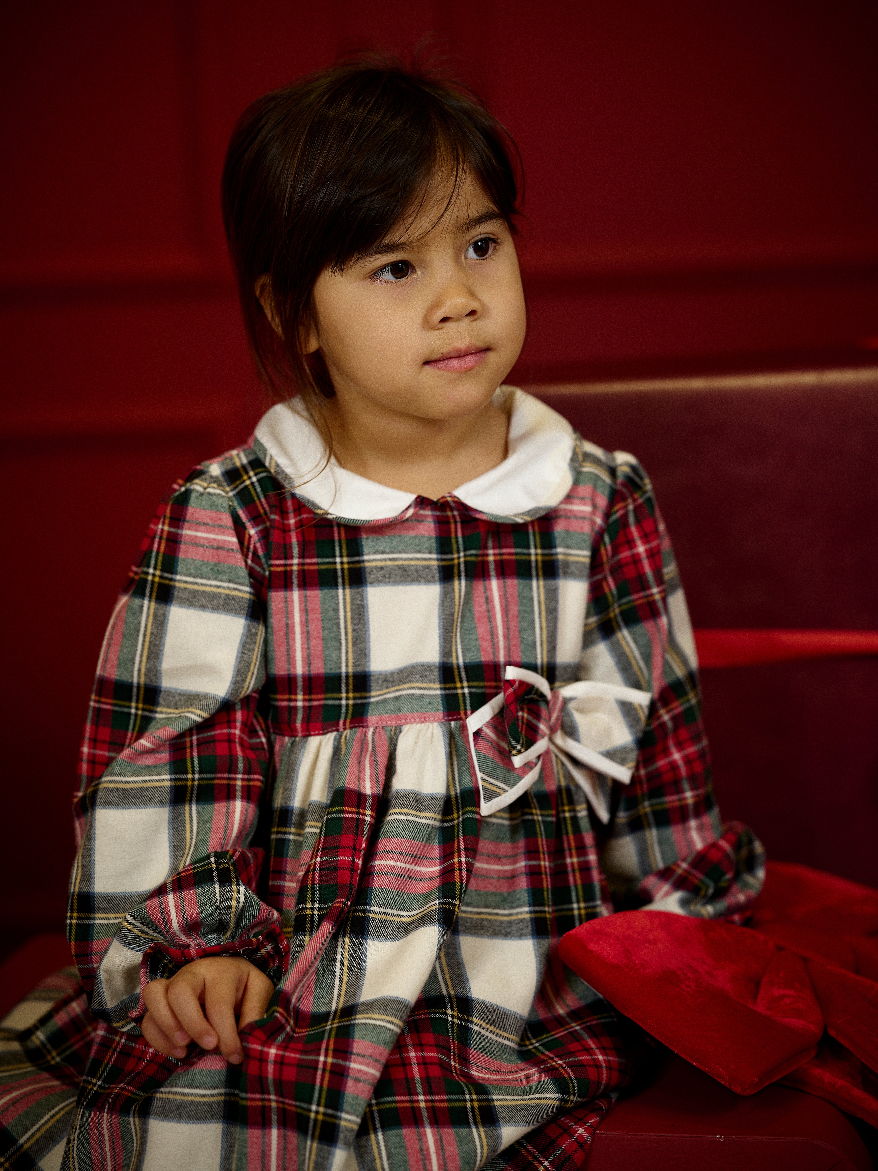 Girl wearing Deolinda Noelle tartan Christmas party dress with white collar