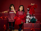 Deolinda Noelle girls tartan Christmas dress in festive campaign setting