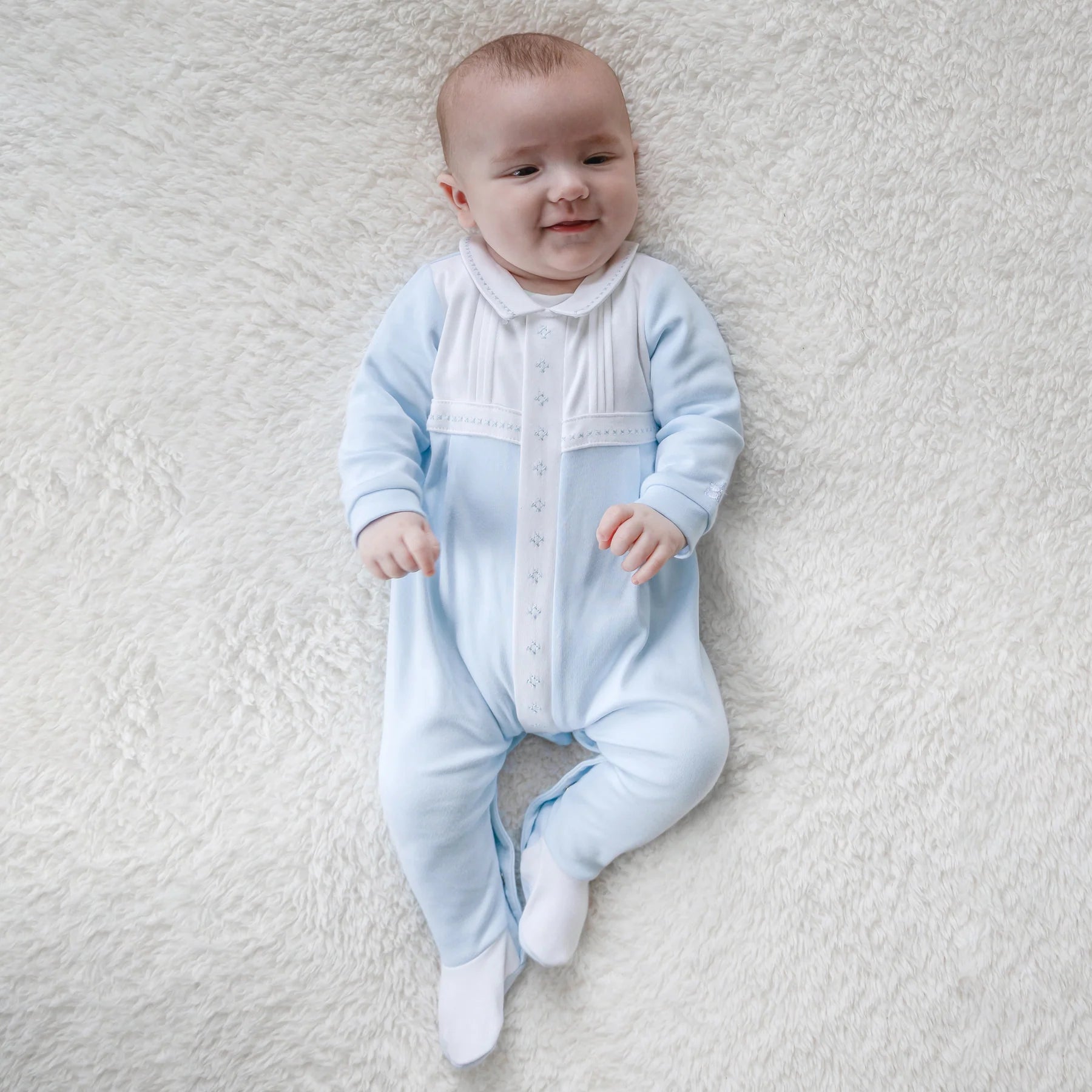 Newborn Baby boy modelling Emile et Rose Matthew blue and white babygrow