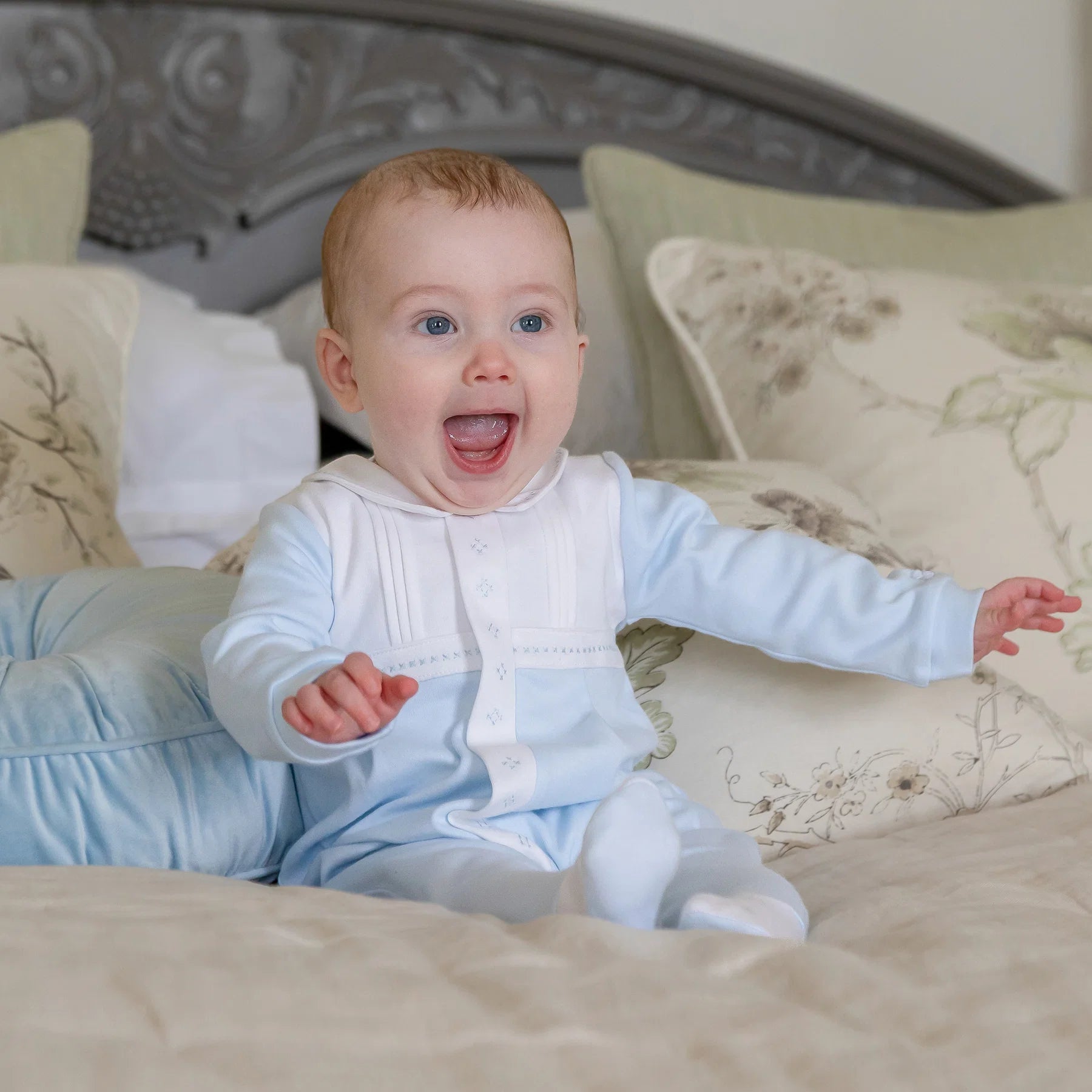  Baby boy wearing Emile et Rose Matthew pale blue and white occasion babygrow