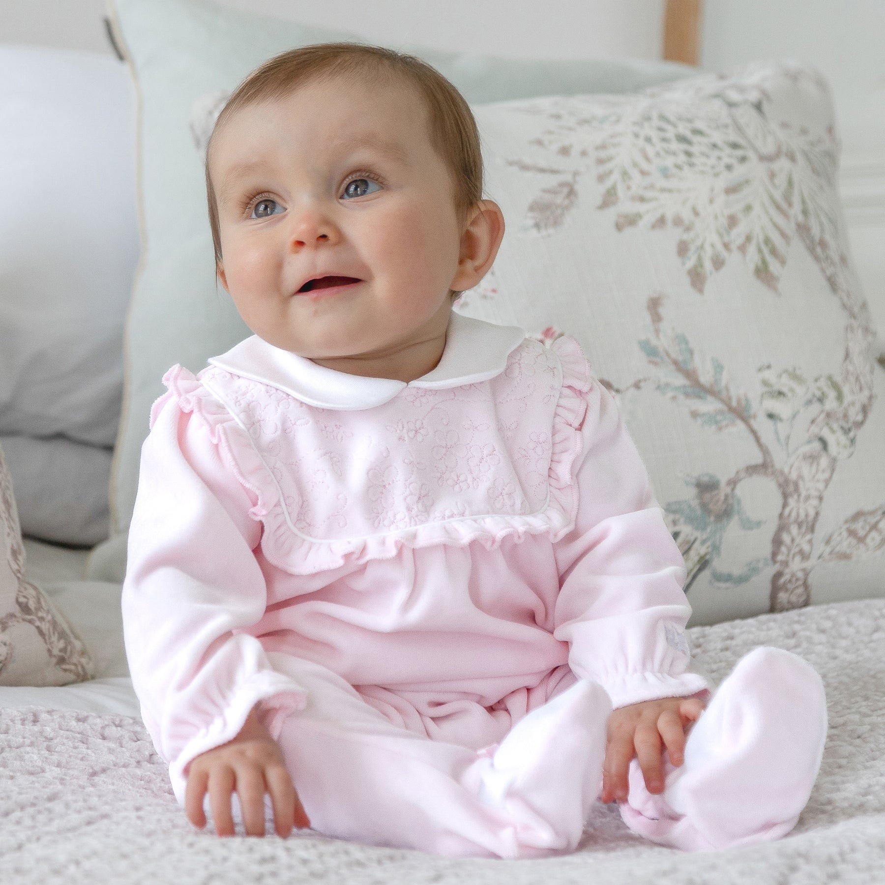 Baby girl wearing Emile et Rose Maddy pale pink velour babygrow