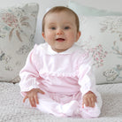 Baby girl wearing Emile et Rose Maddy pale pink velour babygrow