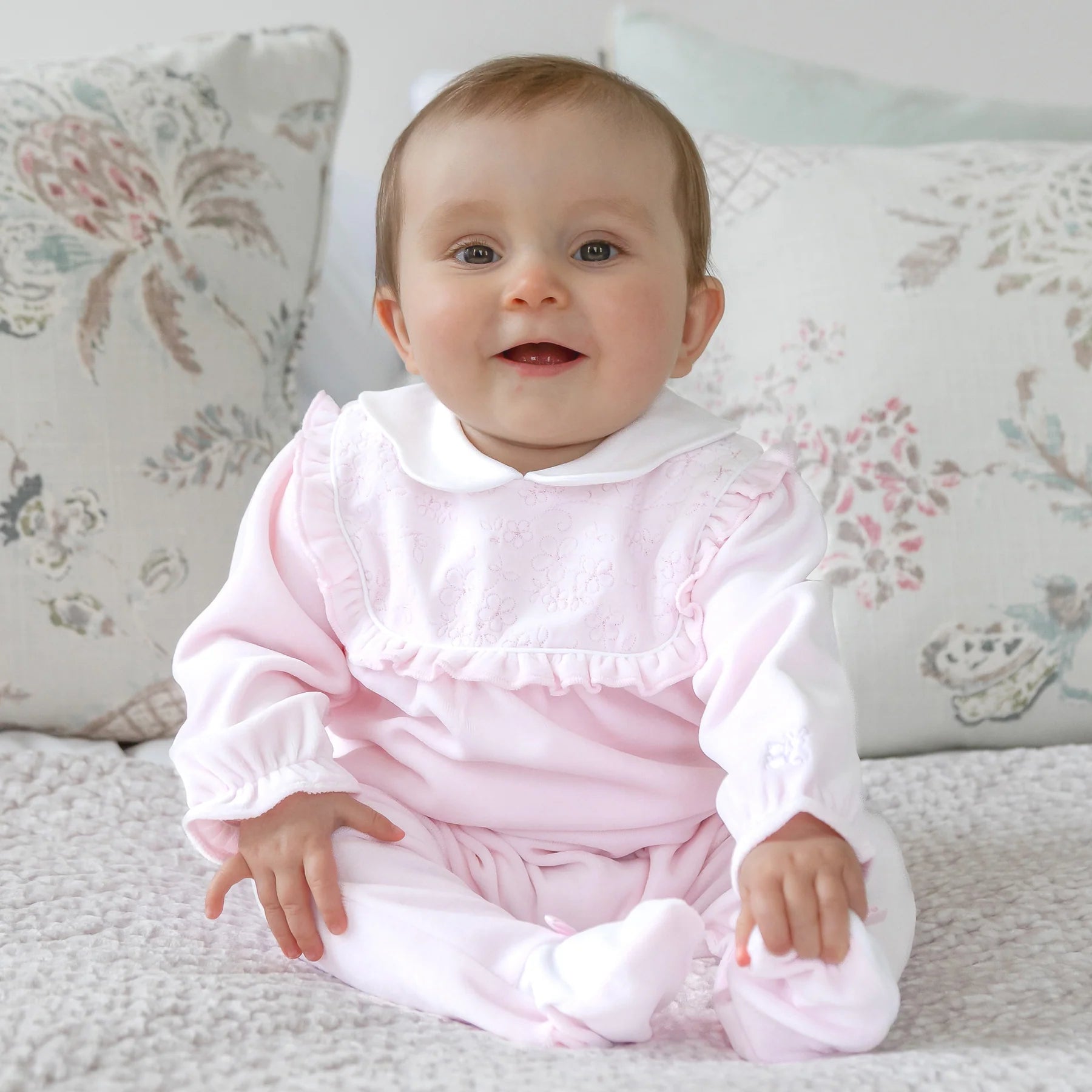 Baby girl wearing Emile et Rose Maddy pale pink velour babygrow
