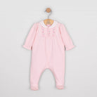 Baby girl in Emile et Rose Madeleine pink babygrow showing full outfit from front