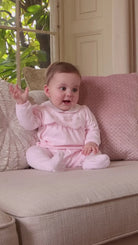 Baby girl wearing Emile et Rose Matilda pink cotton babygrow