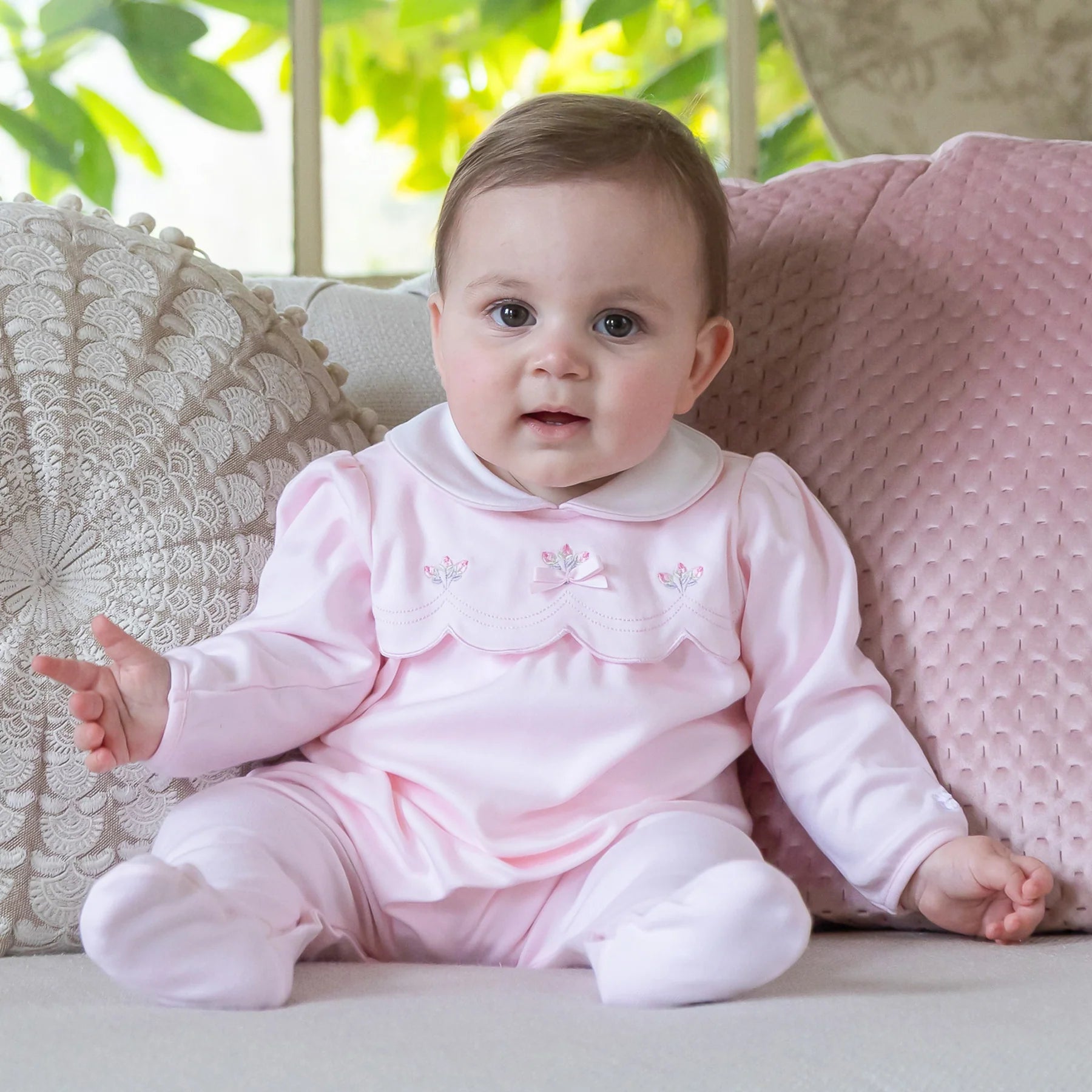 Baby girl wearing Emile et Rose Matilda pale pink romper and hat gift set