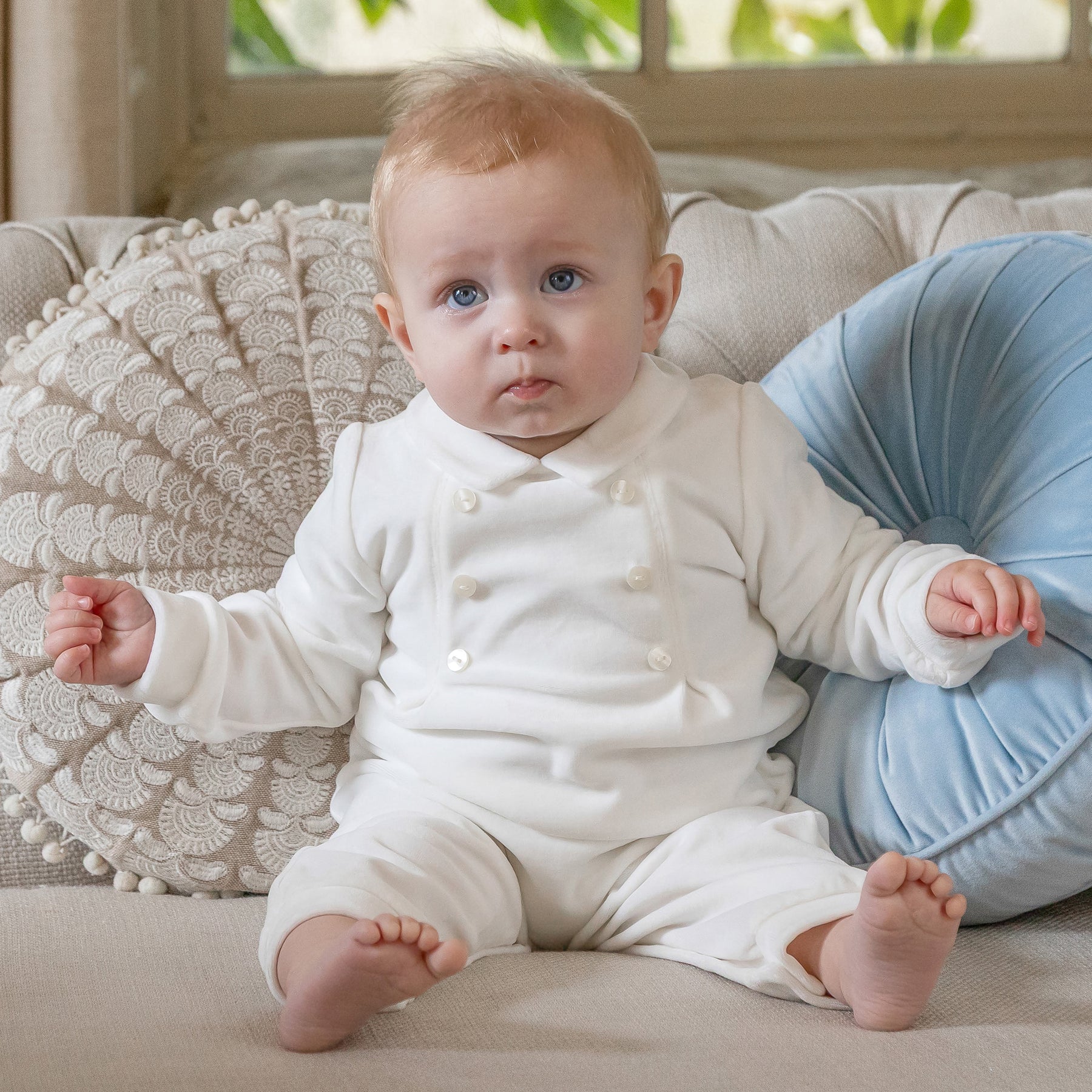 Baby boy wearing the Emile et Rose Marshall ivory velour occasion all in one romper