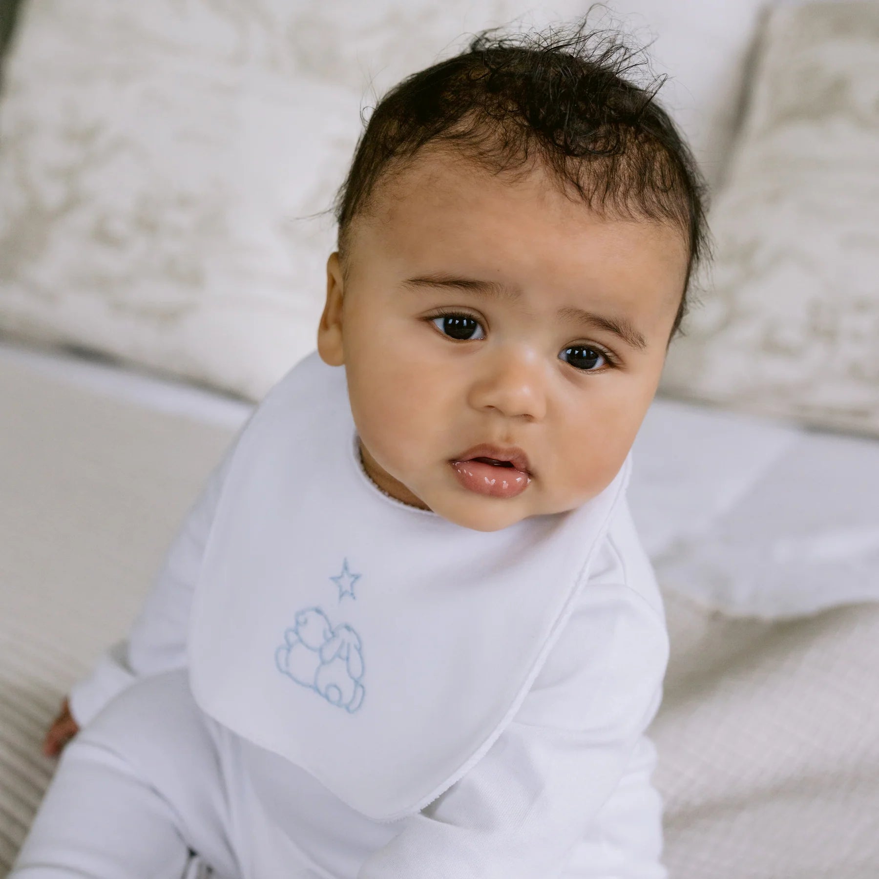 Baby boy wearing the Emile et Rose Trenton pale blue bib