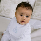 Baby boy wearing the Emile et Rose Trenton pale blue bib