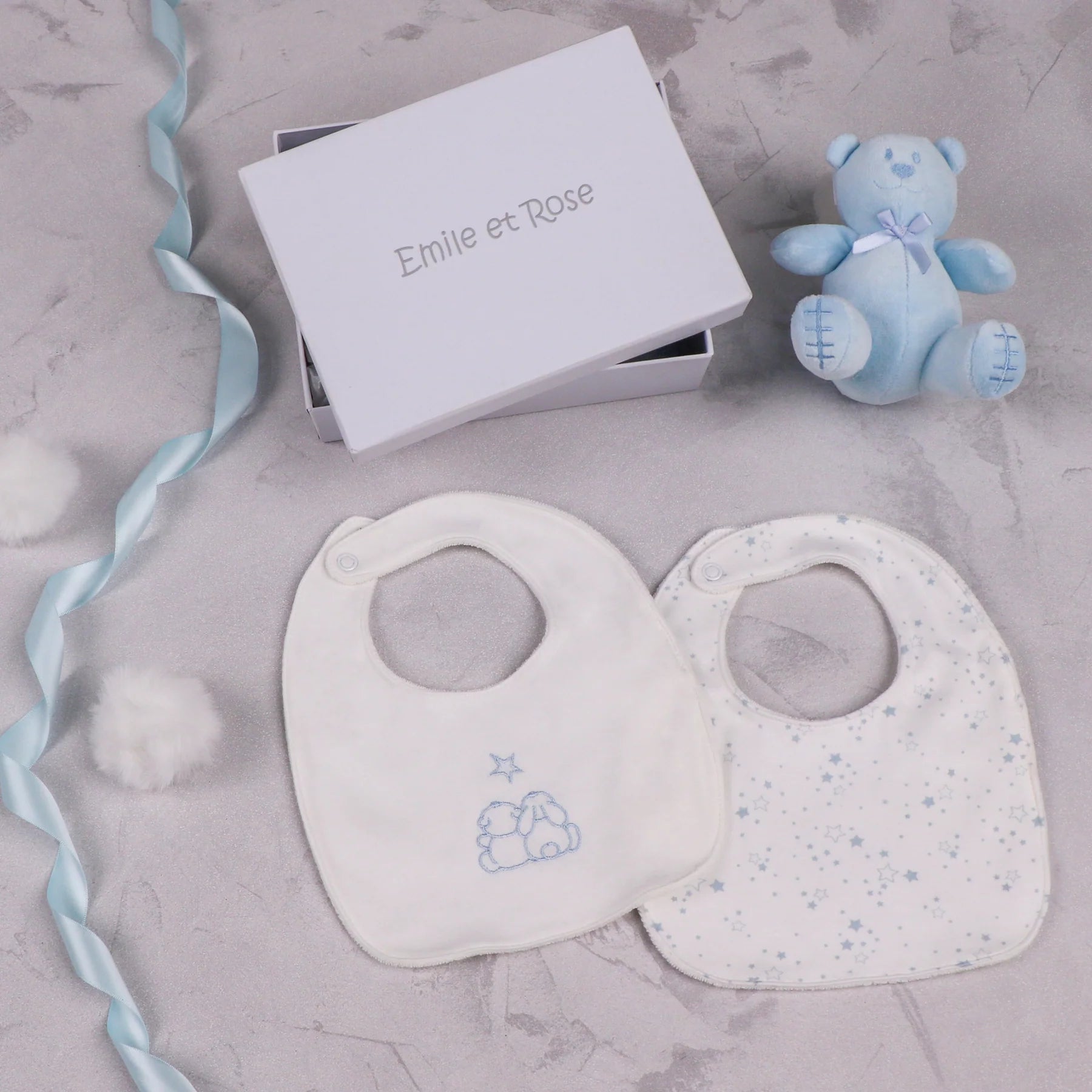 Emile et Rose Trenton pale blue teddy bear and two baby bibs with star print and embroidered design in a white gift box