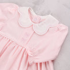 Close-up of the scalloped collar and bow embroidery on the Emile et Rose Maggie baby girls occasion dress