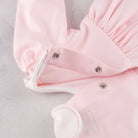 Back popper detail of the Emile et Rose Maggie pale pink baby dress
