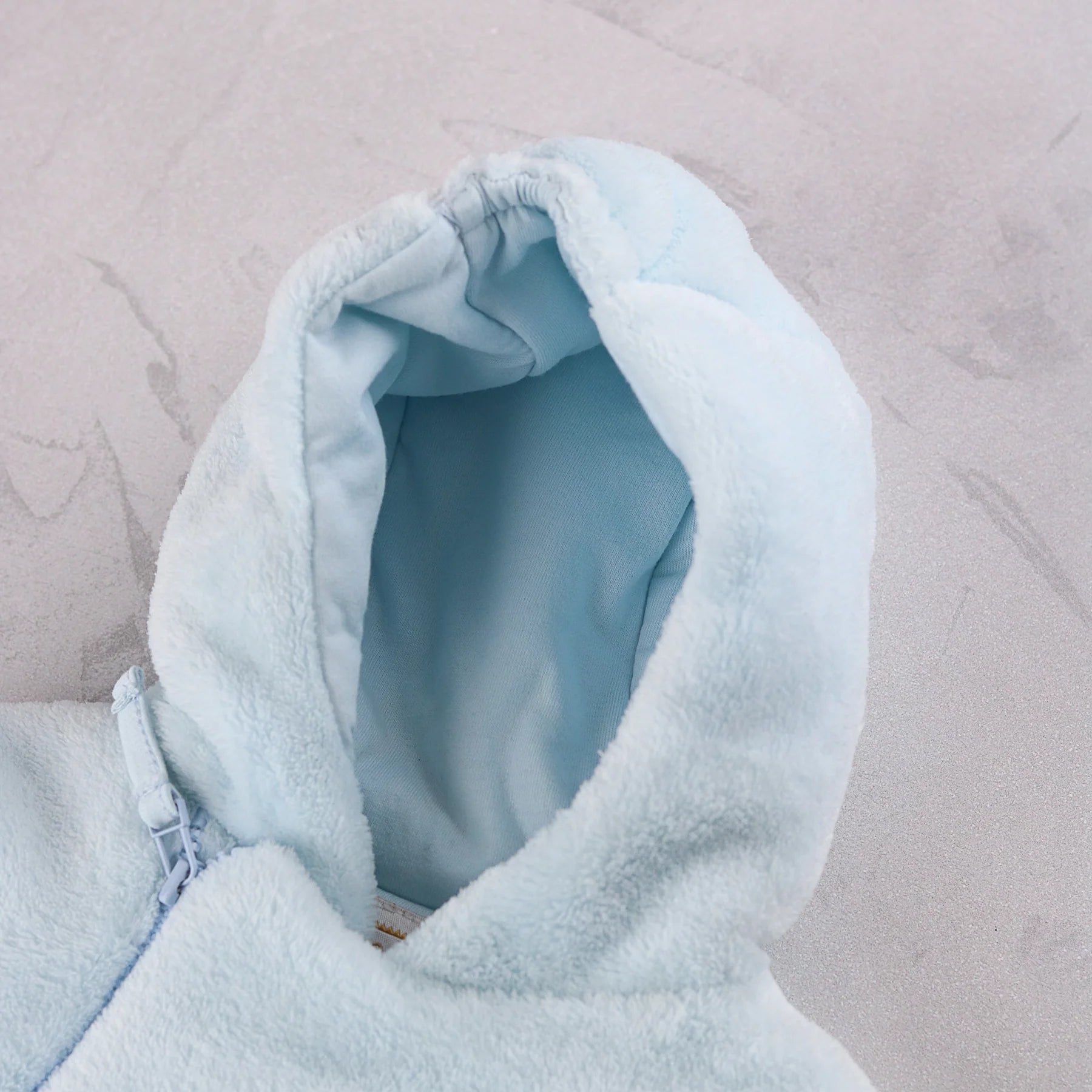 Baby sitting in the Emile et Rose Axel pale blue hooded fleece jacket