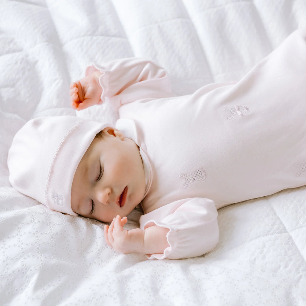 Baby girl lying down in Emile et Rose Kallie Pink Bunny Babygrow & Hat Set