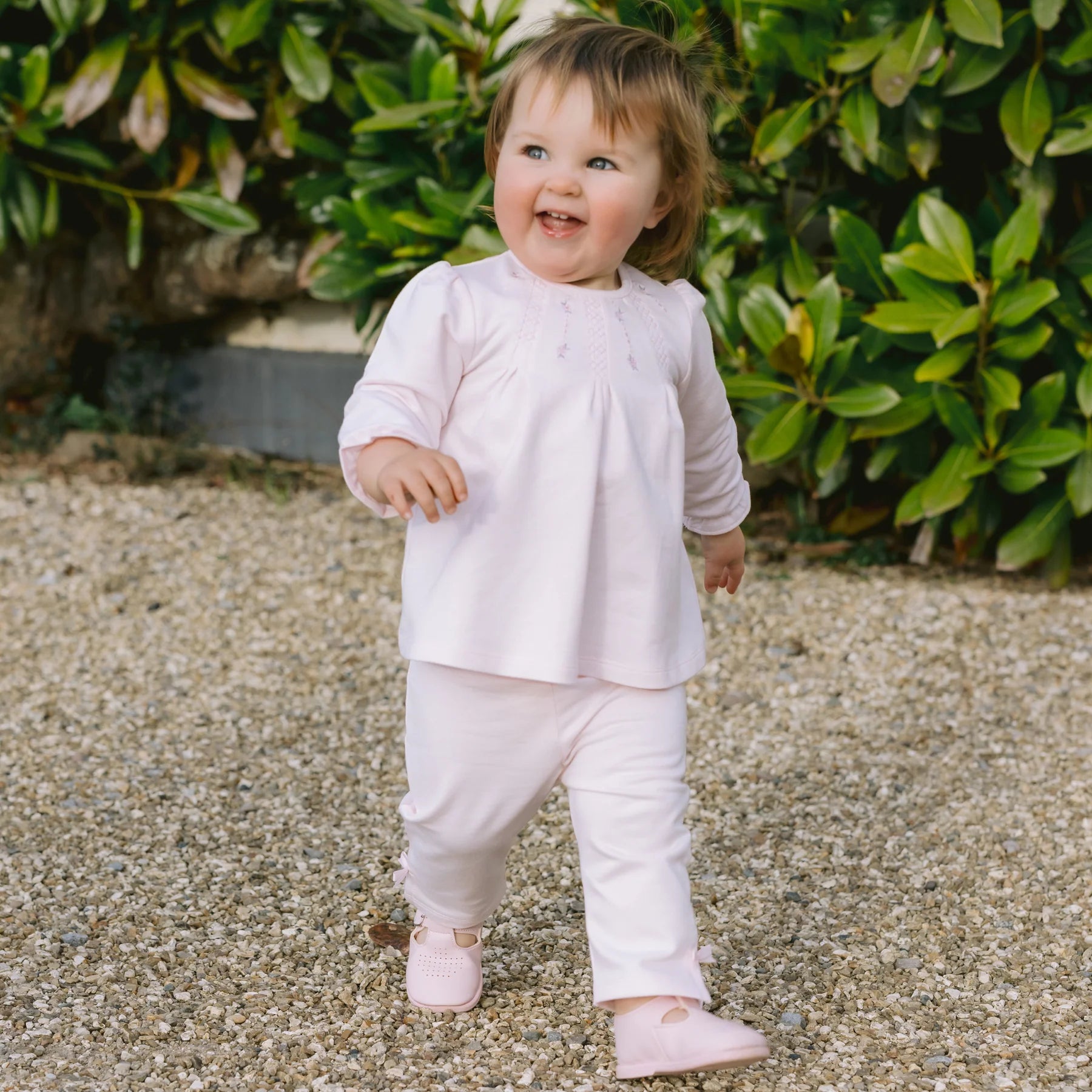 Baby girl wearing Emile et Rose Kate pink top and trousers occasion set,
