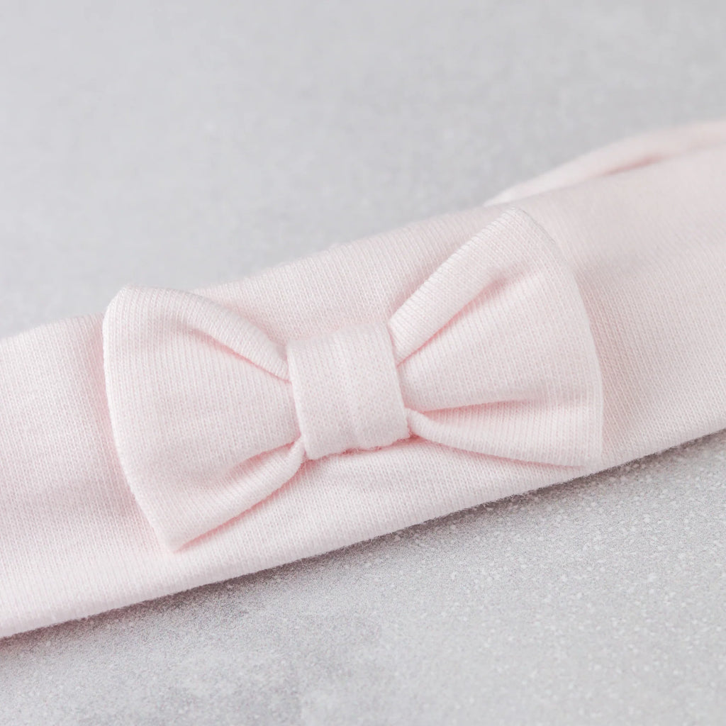 Close-up of pink hairband from Emile et Rose Katerina baby girl set.