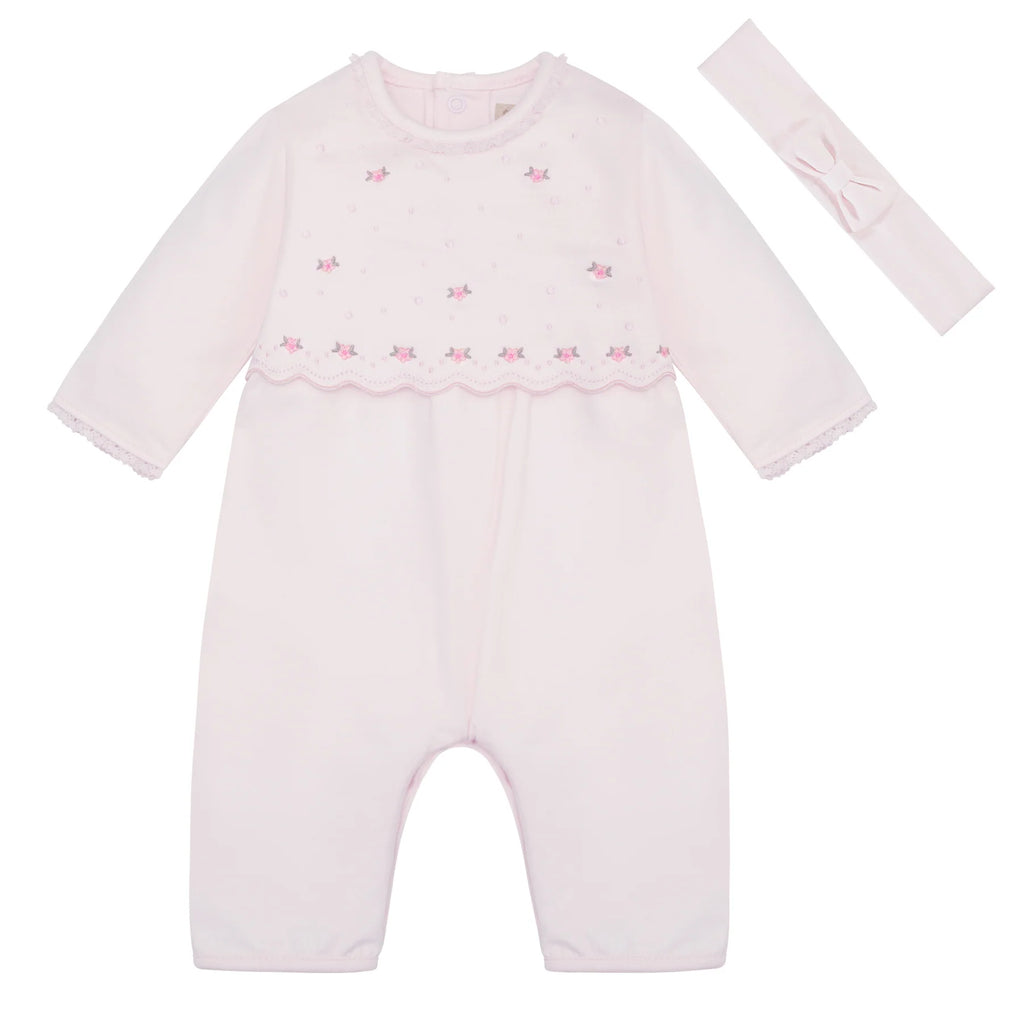 	Flatlay of Emile et Rose Katerina girls pink babygrow and hairband set.
