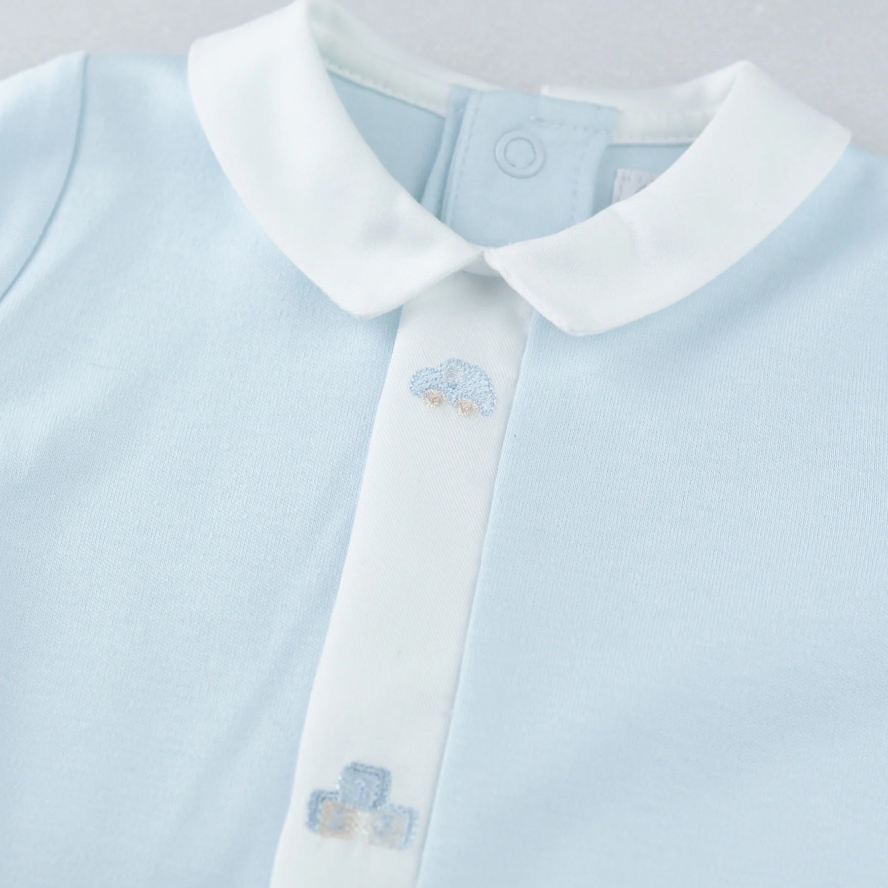 White collar and embroidery detail on Emile et Rose Kent blue boys babygrow.