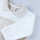 Flatlay of Emile et Rose Kenzie smart knitted babygrow with textured stone knit