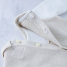 Back button detail on Emile et Rose Kenzie unisex knitted babygrow