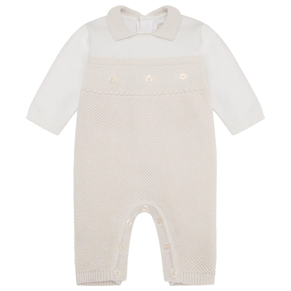Flatlay of Emile et Rose Kenzie unisex knitted babygrow in stone and white