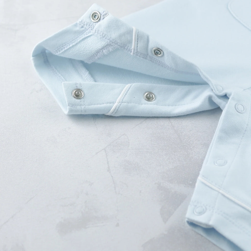 Close-up of leg popper fastening on Emile et Rose Kingsley boys babygrow.