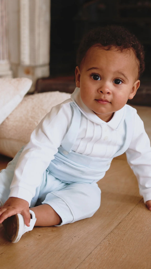 Close-up of baby in Emile et Rose Kingsley outfit, smiling.