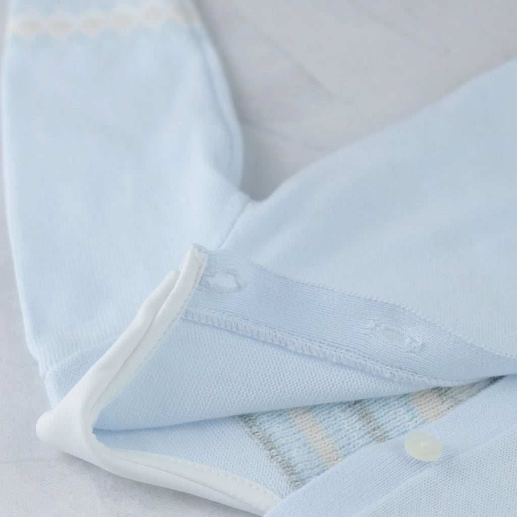 Baby boy sitting indoors wearing Emile et Rose Kipling blue teddy outfit.