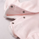 Emile et Rose pink baby babygrow popper fastening detail