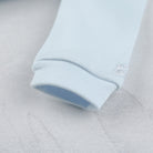 Emile et Rose baby boys blue babygrow close up sleeve hem detail