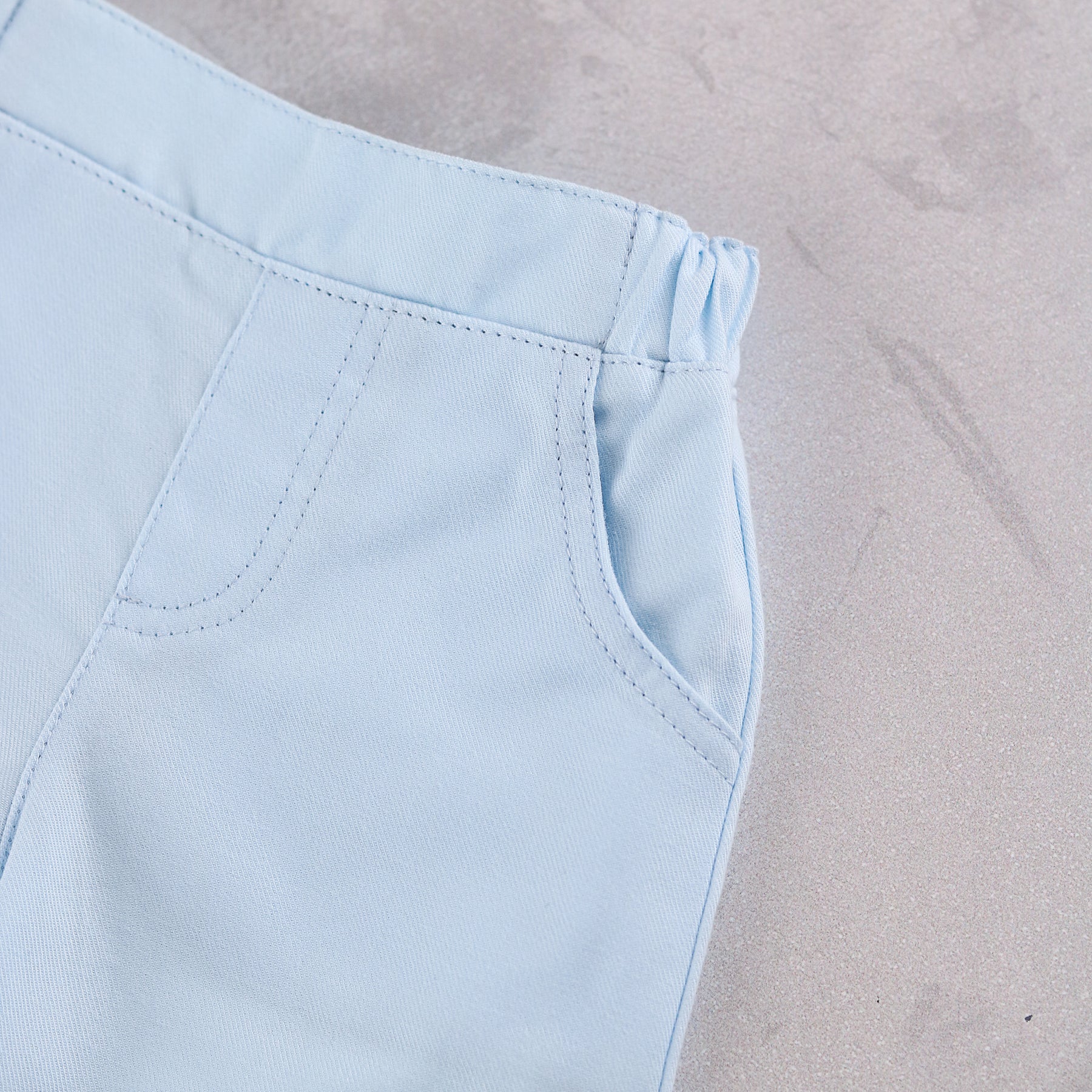 Close-up of Emile et Rose Martin ktrousers with elastic waistband