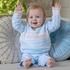 Baby boy wearing Emile et Rose Martin pale blue knitted outfit set