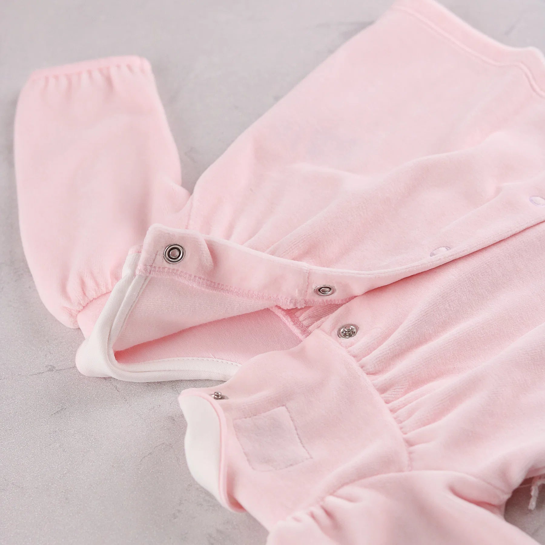 Back view of the Emile et Rose Michelle pale pink baby girls velour outfit showing popper fastening