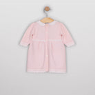 Back view of the Emile et Rose Millie pale pink knitted baby girls dress